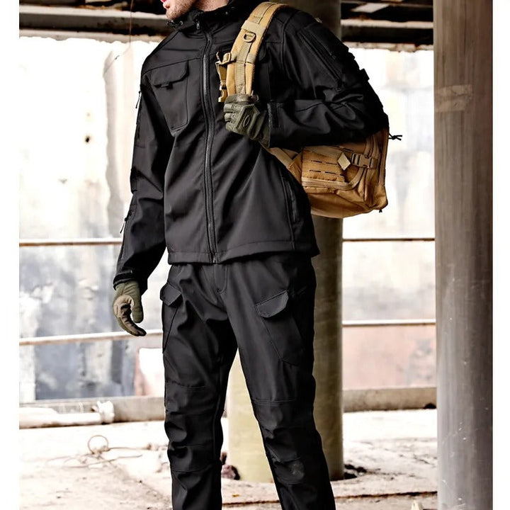 Men's tactical waterproof outdoor set: dark green jacket and trousers. Windproof gear for hiking and rain.