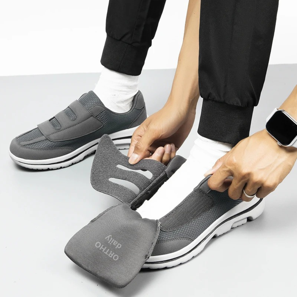 Man walking in comfortable wide fit orthopedic slip-on shoes with adjustable Velcro, ideal for daily wear.