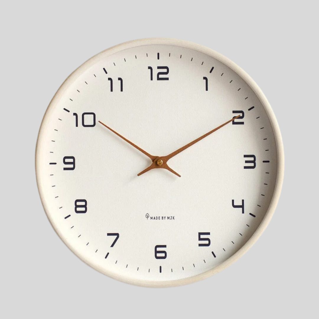 Modern minimalist wood wall clock with quiet quartz movement, available in brown or cream. Elegant home accent.