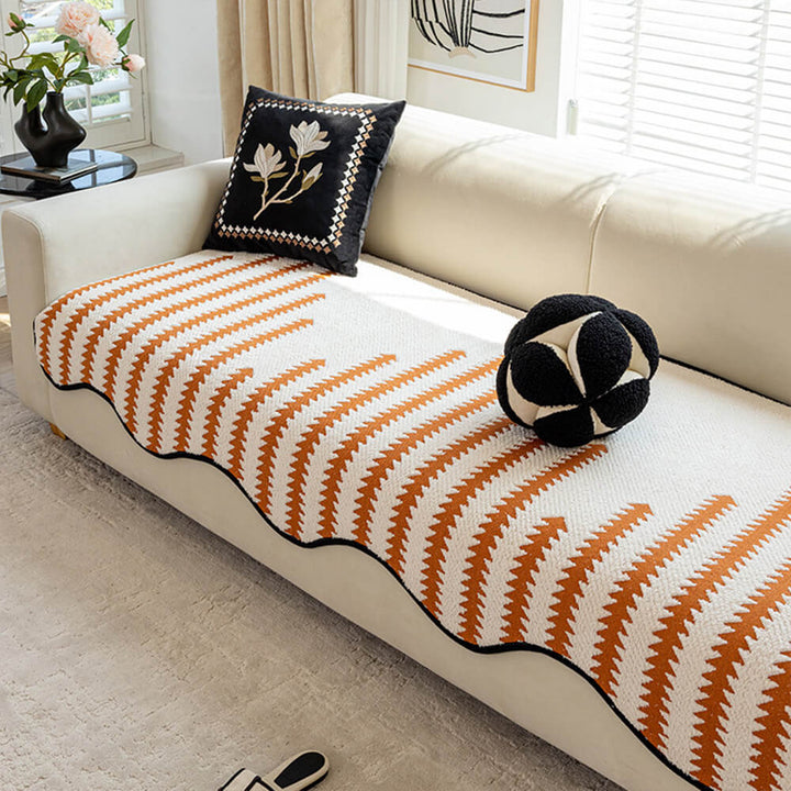 Elegant modern chevron stripe couch cover with wavy edges. Offers pet-friendly protection and home decor upgrade.
