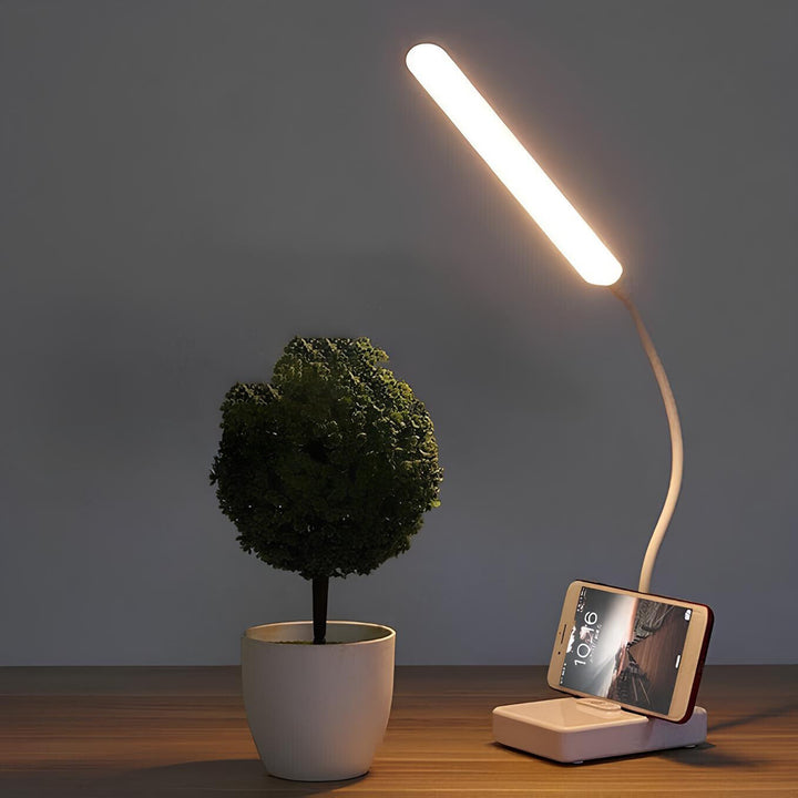 Modern LumoFlex LED desk lamp with flexible arm for home office & workspace. Dimmable task light for reading.