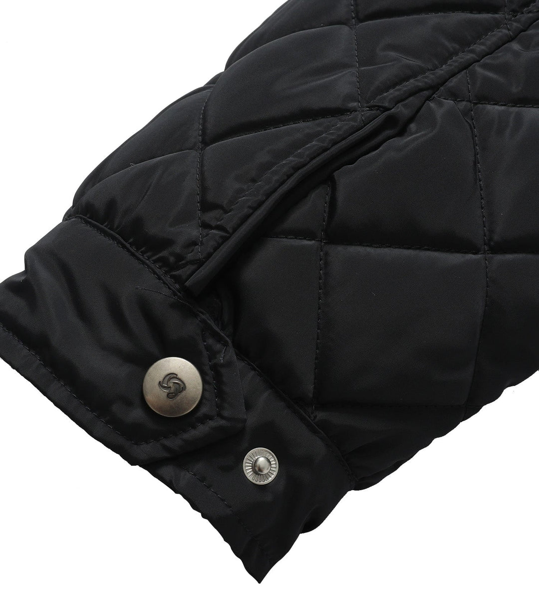 Flat lay of a women's quilted vest, showcasing its design and readiness for outerwear fashion.