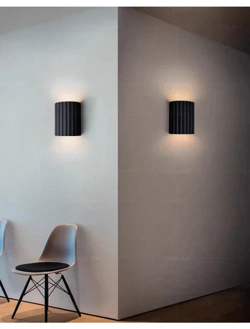 Stylish resin wall lamp, a unique modern lighting fixture enhancing any room. Provides ambient LED light.