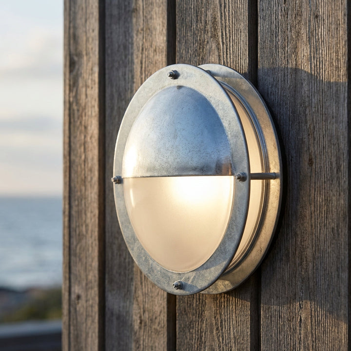 Modern round galvanized steel outdoor wall light, weatherproof for porch & entryway exterior lighting.