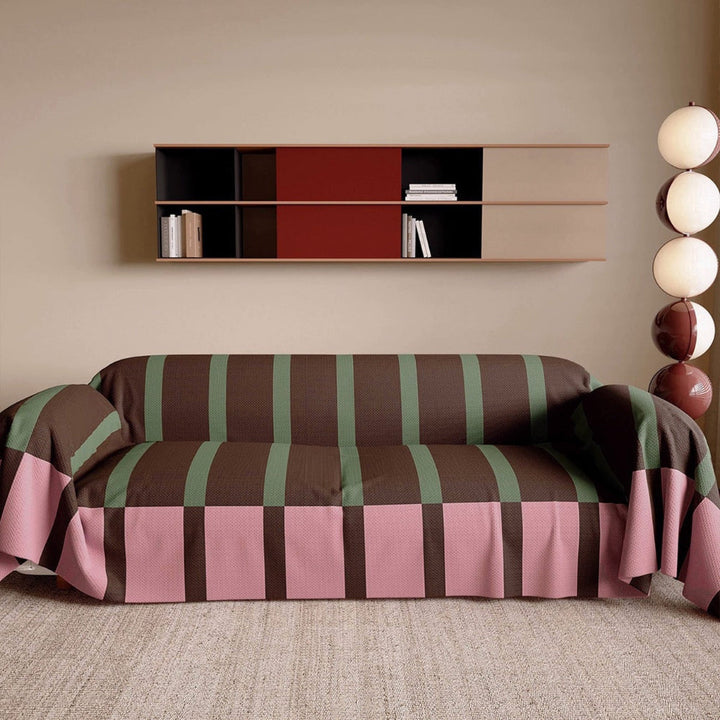 Vibrant contemporary striped couch cover, modern geometric design. Stylish living room furniture protector.
