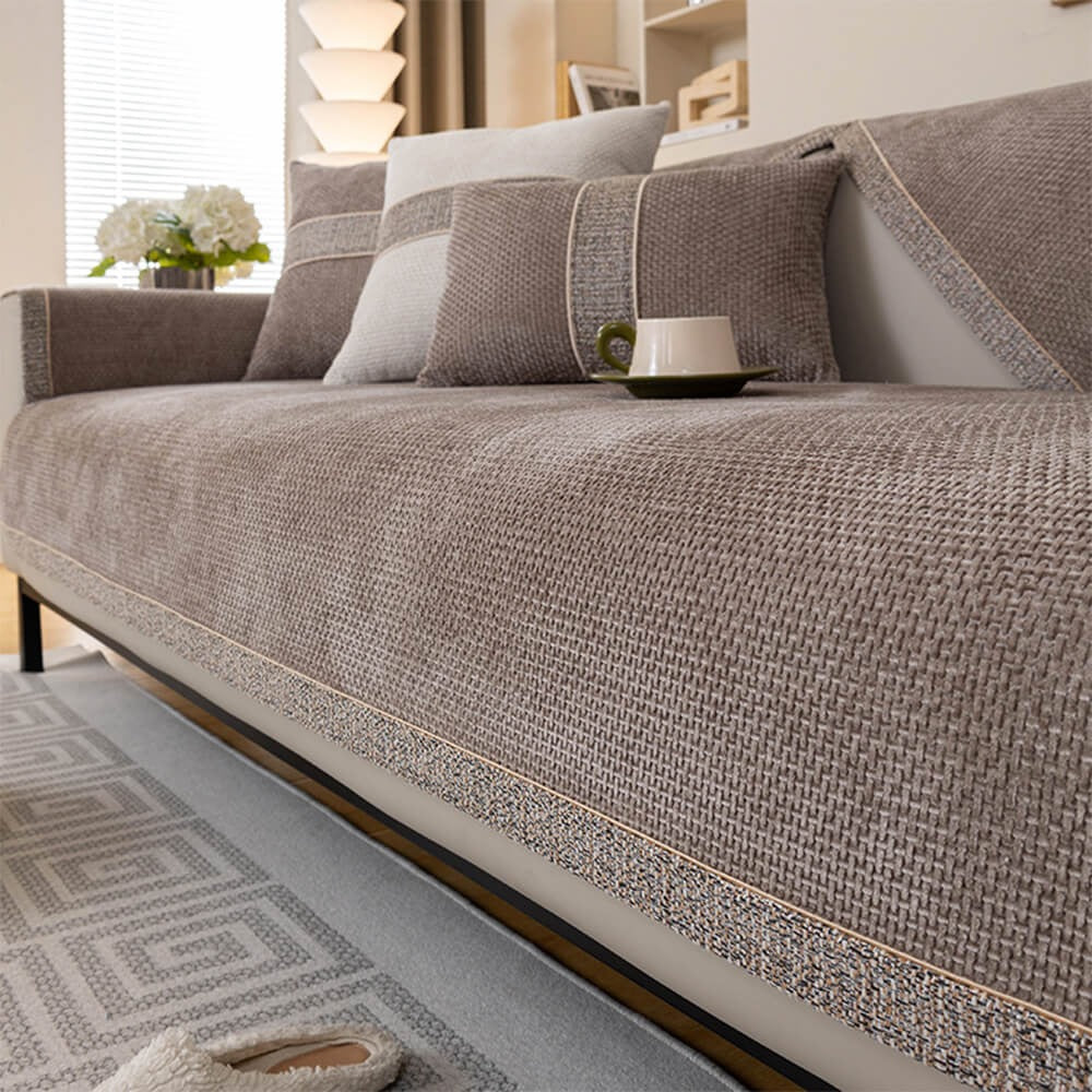 Close-up of modern tweed anti-slip sofa cover fabric. Woven texture, durable furniture protector for any home.