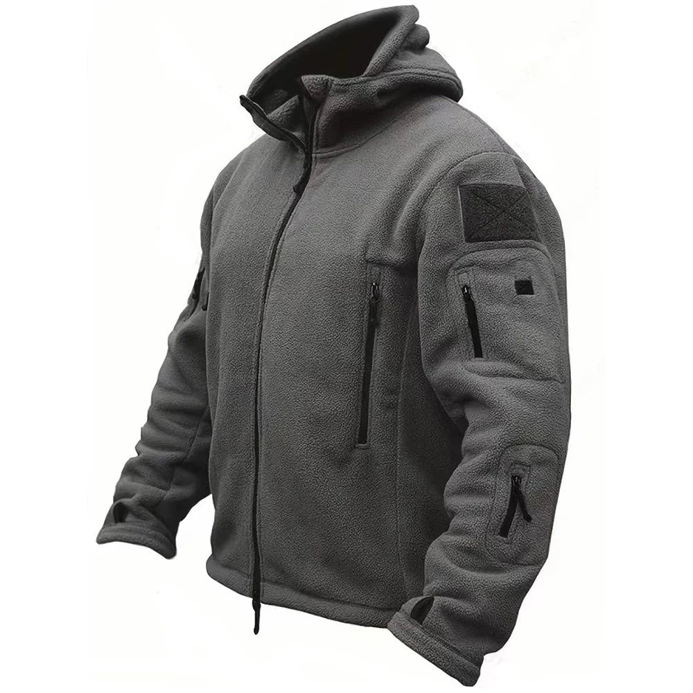 Side view of a man wearing a black tactical hooded jacket, ready for outdoor adventure and functional use.