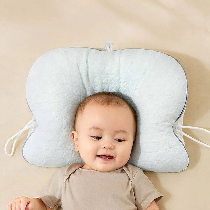 Portable baby travel pillow, offering flat head prevention & ergonomic head support for newborns & toddlers.
