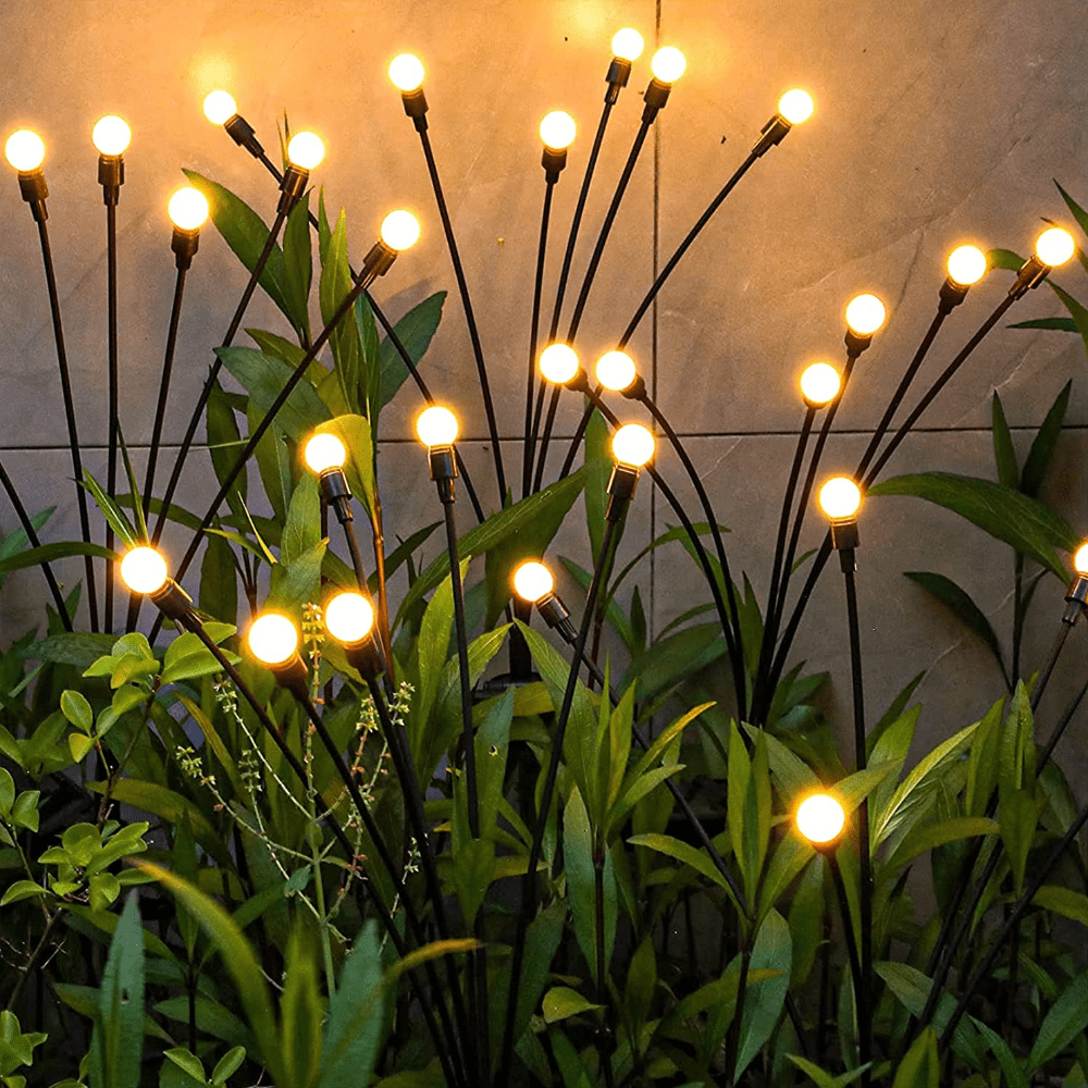 "Outdoor solar firefly garden lights with glowing LED bulbs on tall stakes, IP65 waterproof for enchanting yard decor."