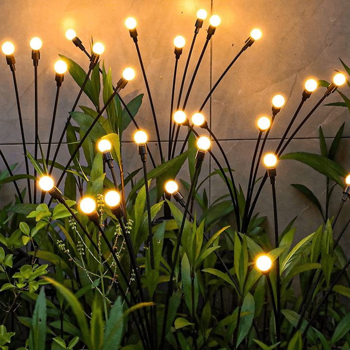 "Outdoor solar firefly garden lights with glowing LED bulbs on tall stakes, IP65 waterproof for enchanting yard decor."