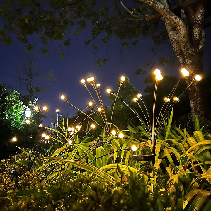 "Outdoor solar firefly garden lights with glowing LED bulbs on tall stakes, IP65 waterproof for enchanting yard decor."
