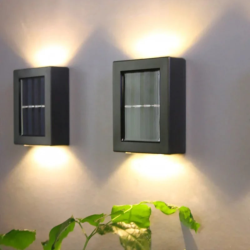 Wireless solar LED pathway light illuminating a dark garden wall at night. Bright & energy-saving outdoor lamp.