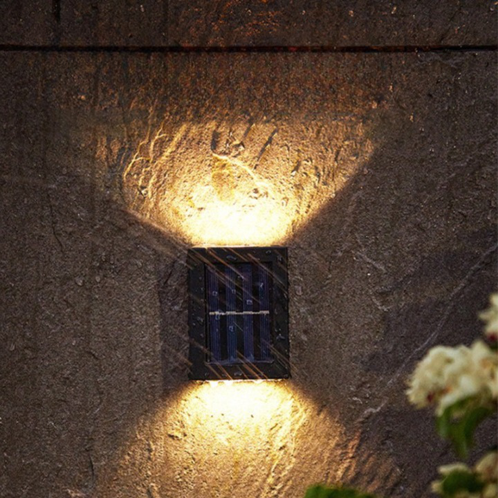 Multiple outdoor wireless solar LED wall lamps enhancing garden security & patio ambiance. Efficient exterior lighting.