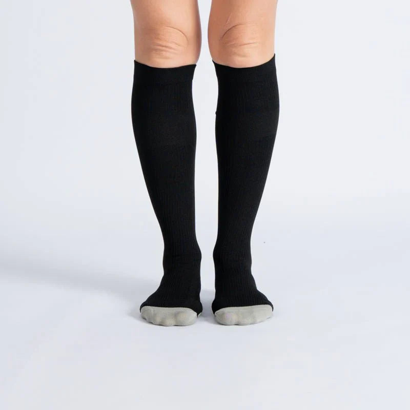Pair of black and white unisex gentle compression socks for daily wear and improved circulation