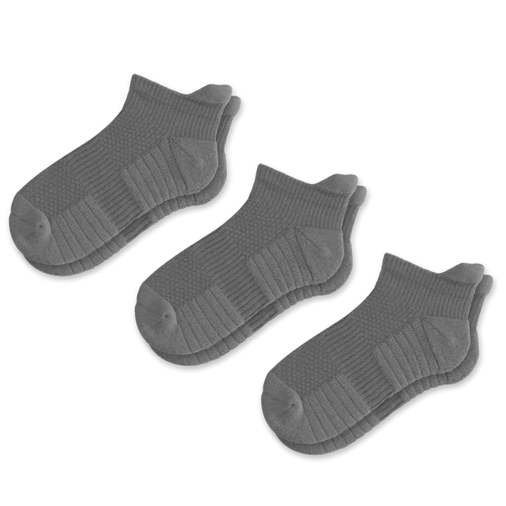 Close-up of the sole of a gray compression sock, showing reinforced areas for comfort and durability.