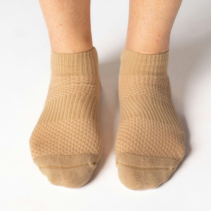 Two tan unisex ankle socks, designed for mild compression and comfortable foot and ankle support.