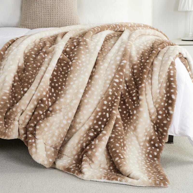 Elegant deer motif on a reversible faux fur blanket, adding winter comfort and style to any room.