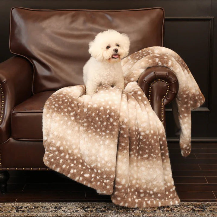 Cozy home bedroom with a plush faux fur deer throw blanket draped on the bed, inviting warmth.