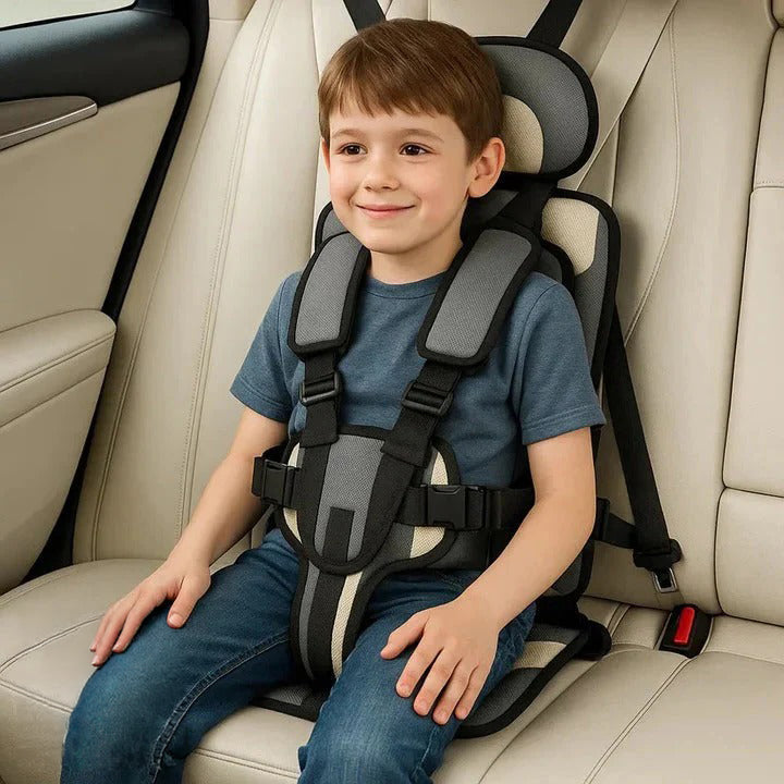 Child in a portable car travel seat with a secure 5-point safety harness, ensuring road trip safety.