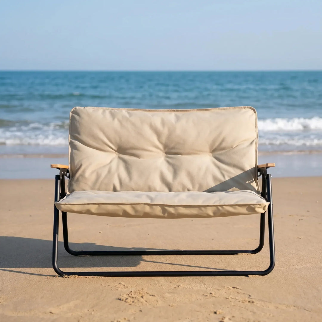 Portable two-person folding camping sofa, sturdy & comfortable for outdoor relaxation.