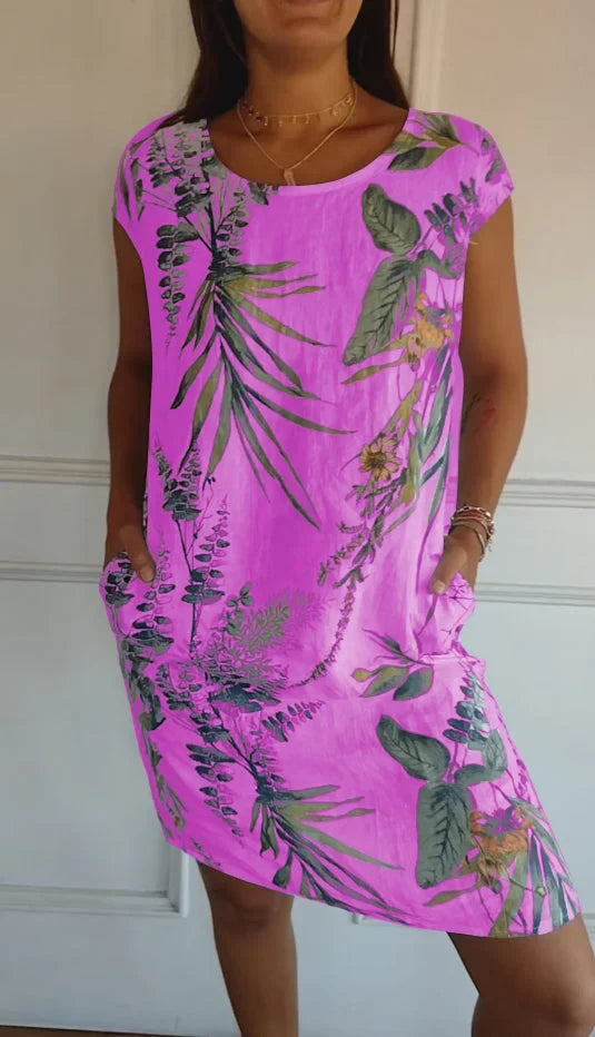 Model wearing a women's flowy printed round neck dress. Knee-length, comfortable, and elegant for summer.
