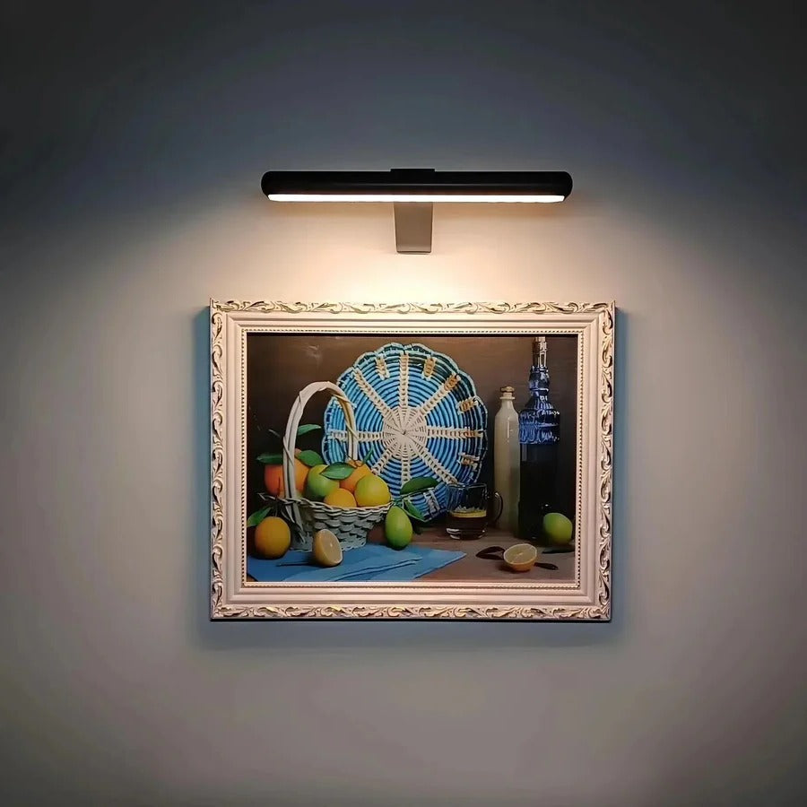 Cordless LED wall light for flexible artwork display. Rechargeable design for clean, modern home accent lighting.