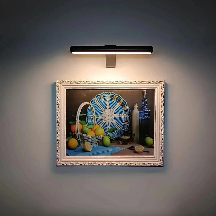 Cordless LED wall light for flexible artwork display. Rechargeable design for clean, modern home accent lighting.
