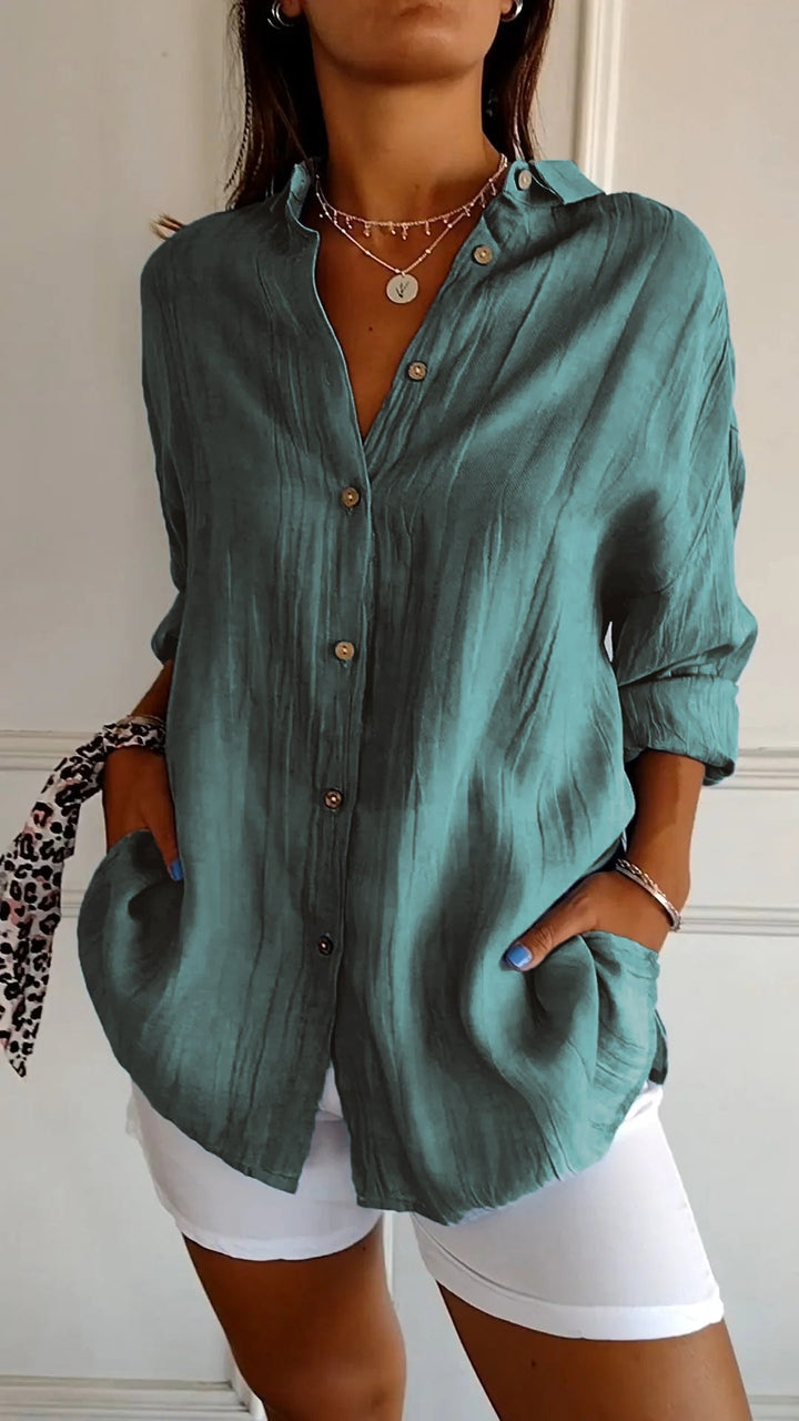 Women's collared button-down shirt, relaxed fit with stylish roll-up sleeves.