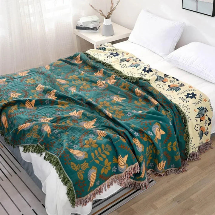 Reversible Scandinavian bird design cotton throw blanket for cozy living room decor.