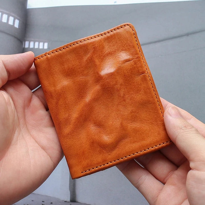 Closed full grain leather tri-fold wallet for men, showcasing rich texture and compact design