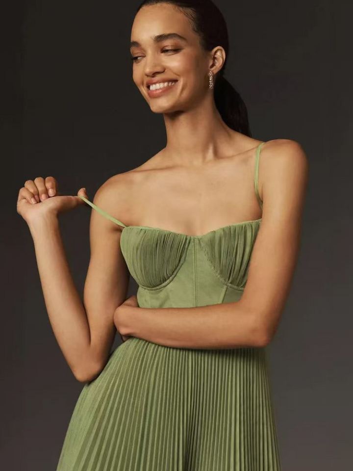 Elegant women's sage green pleated maxi dress, a corset-style wedding guest gown.