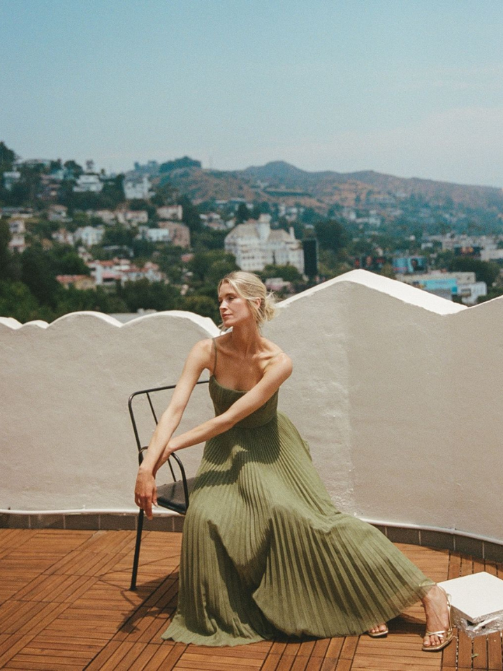 Elegant women's sage green pleated maxi dress, a chic corset wedding guest outfit.