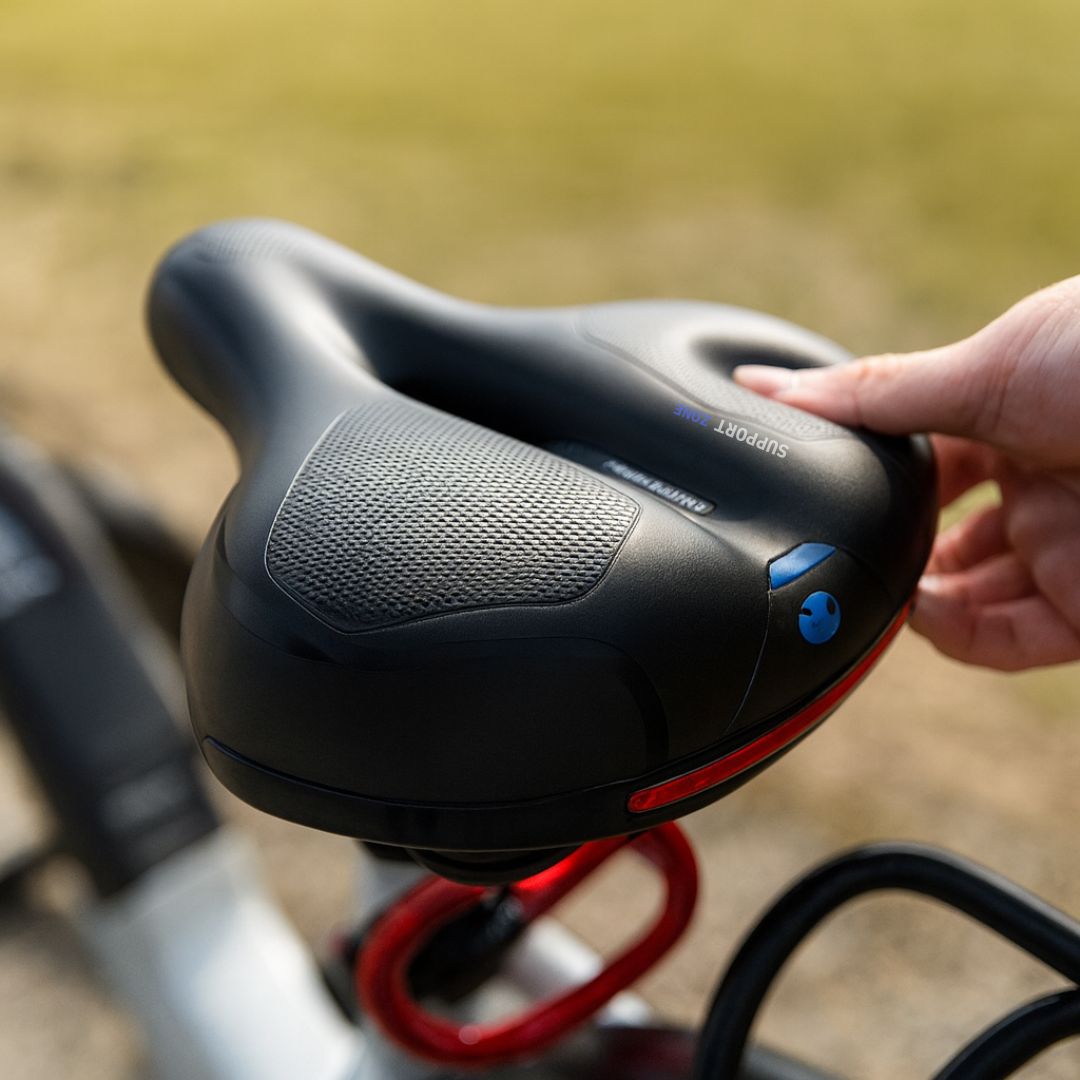 Blue comfortable bicycle seat featuring integrated suspension & ergonomic design. Unisex bike saddle for long rides.