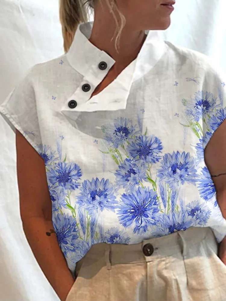 Chic women's short-sleeve blouse with vibrant floral print, great for office or casual summer style.
