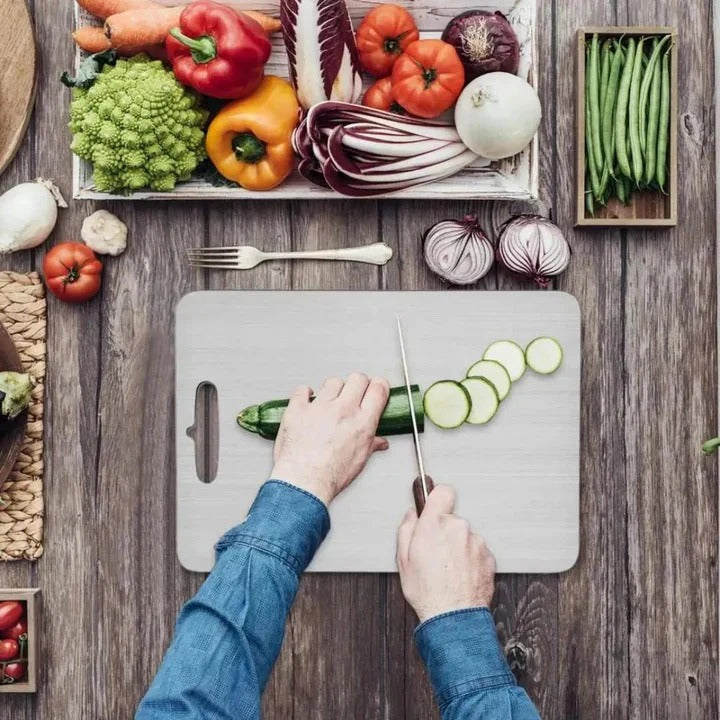 Sleek titanium cutting board for hygienic food prep. Durable, non-porous, and dishwasher safe kitchen accessory.