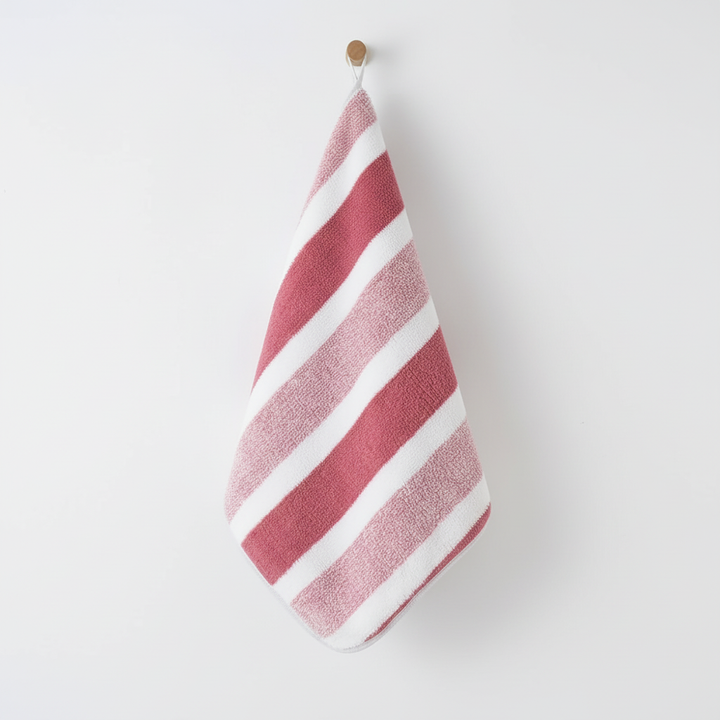 Striped coral fleece towel set for bathroom. Soft, absorbent polyester towels, perfect for modern home decor.