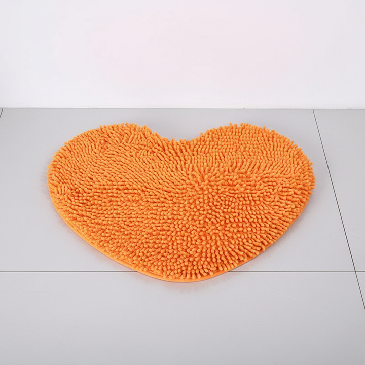 Luxurious heart-shaped microfiber chenille bath mat, perfect for soft, absorbent home comfort.