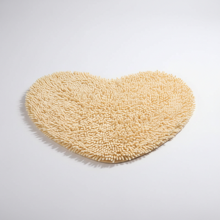 Soft heart-shaped bath mat in plush chenille, offering absorbent and anti-slip comfort for any bathroom.