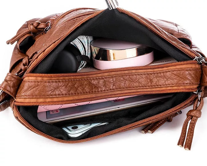 Black soft leather shoulder bag for women. Chic everyday handbag, spacious, and an elegant fashion accessory.