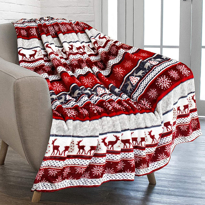 Soft Nordic plush throw blanket (51x59in) with festive red & green reindeer & snowflake pattern for cozy winter decor.