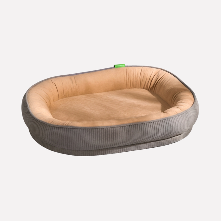 Happy pet in a fluffy washable dog nest bed. A cozy, soft, plush pet bed for deep slumber.