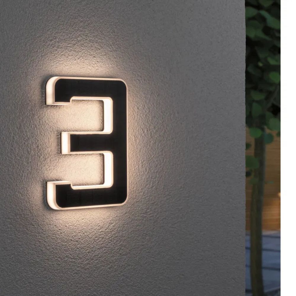 Sleek illuminated house number plaque, enhances home exterior & garden decor with modern design.