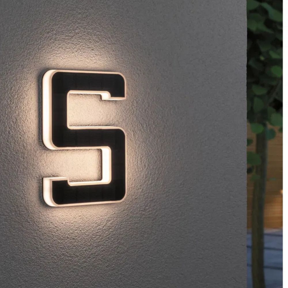 Bright solar illuminated house number display for improved night visibility and address aid.