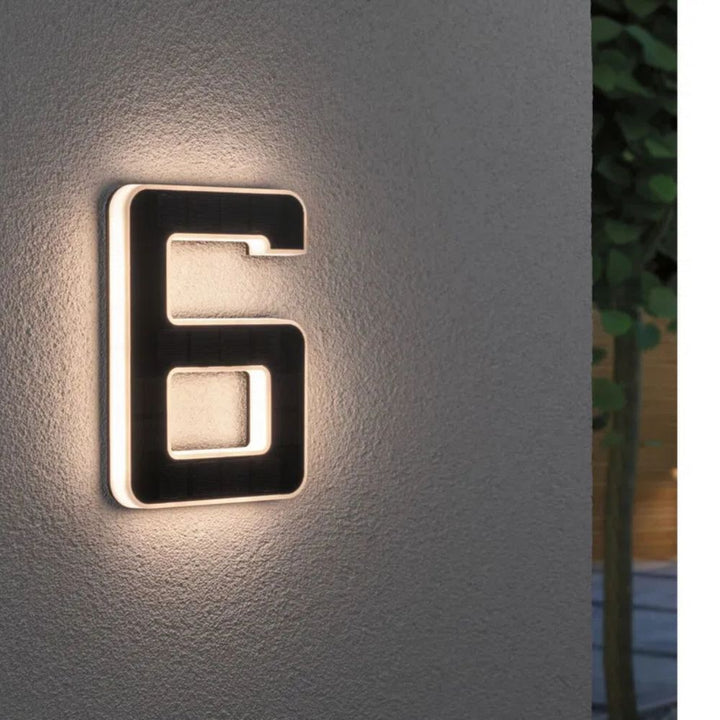 Front view of modern solar house number sign, lit for evening visibility, sleek home exterior decor.