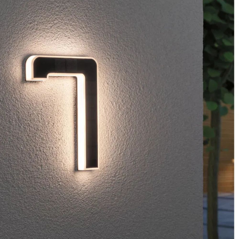 Daytime view of sleek solar-powered house numbers on a home exterior, ready for night illumination.