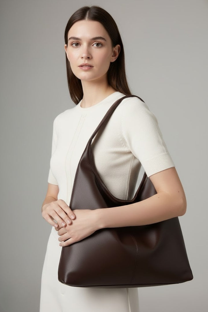 Close-up of the spacious interior of a women's everyday carryall handbag, showing organized pockets and ample room.