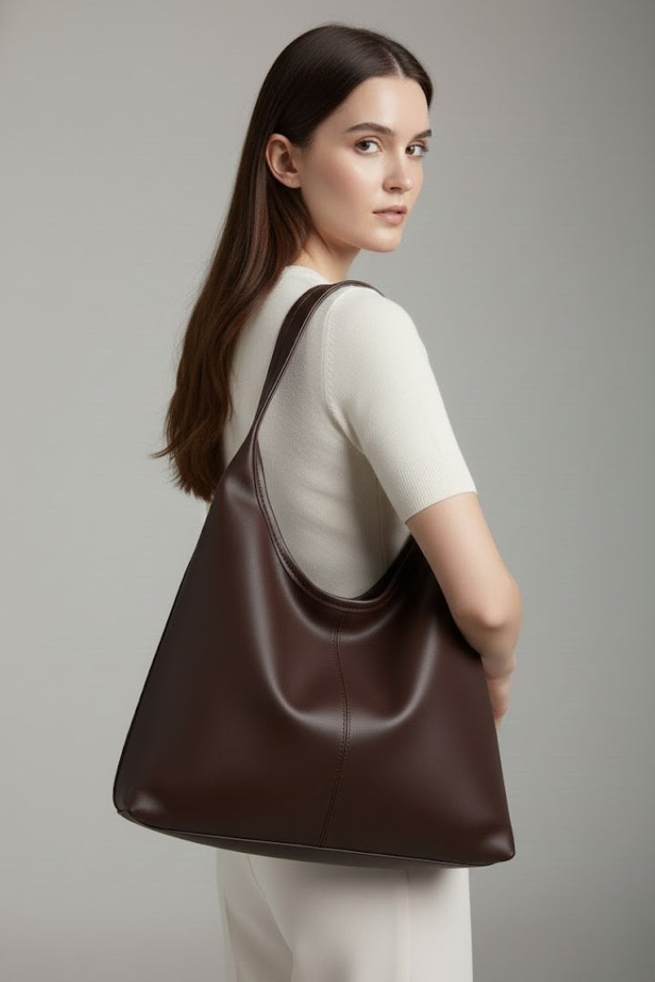 Women's black shoulder bag, an elegant and spacious everyday handbag. Features a secure zippered top and versatile design.