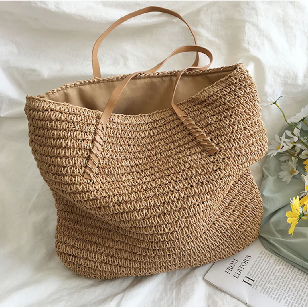 Women's TerraWoven carryall bag, designed with a sturdy shoulder strap and intricate woven pattern for durability.