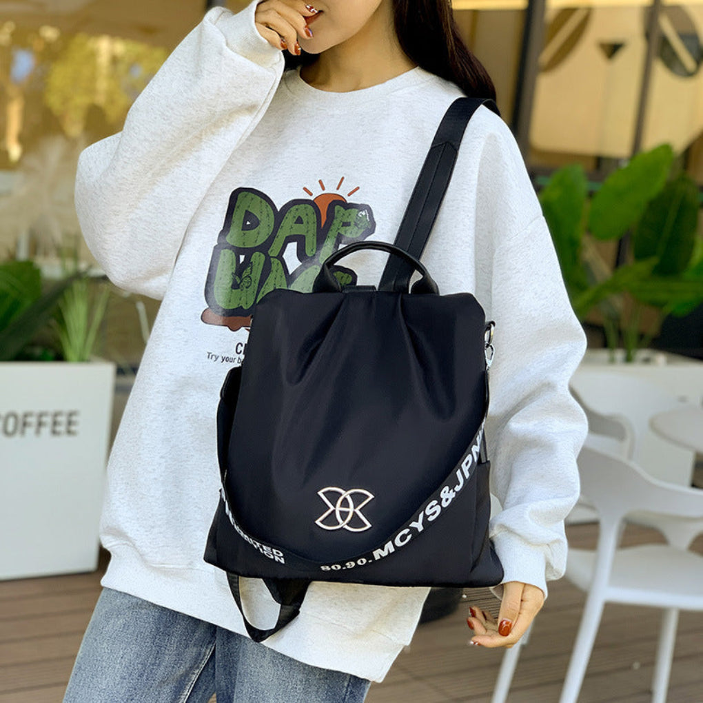 Stylish black women's anti-theft convertible backpack, perfect for travel & daily use as a shoulder or back bag.