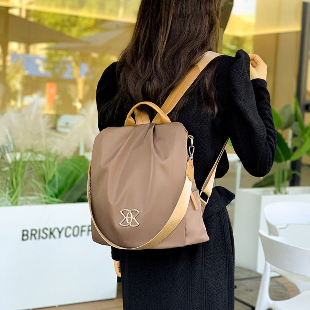 Secure & stylish women's brown anti-theft convertible backpack, ideal for daily commutes & travel.